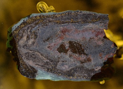 : Polished ore section (embedded in resin) with chalcopyrite and rare silver selenides. Locality: Lorüns limestone quarry, Montafon, Vorarlberg, Austria (catalogue no. O 1971).